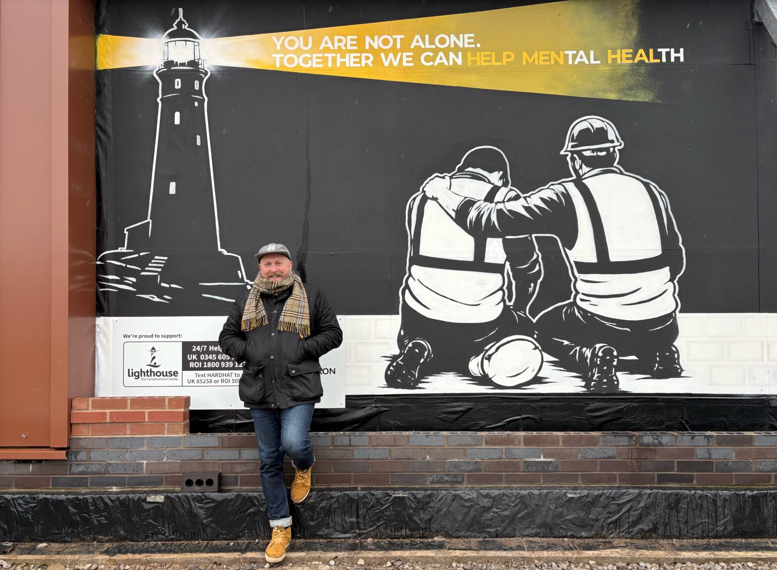 Artist Rob Fenton with the Lighthouse Charity mural